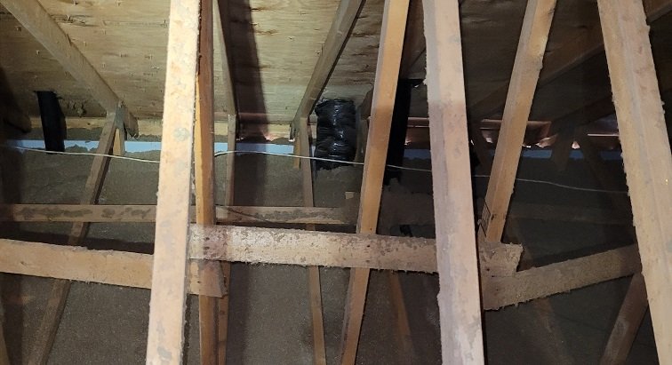 Insulated exhaust line in an attic connected to a proper roof vent
