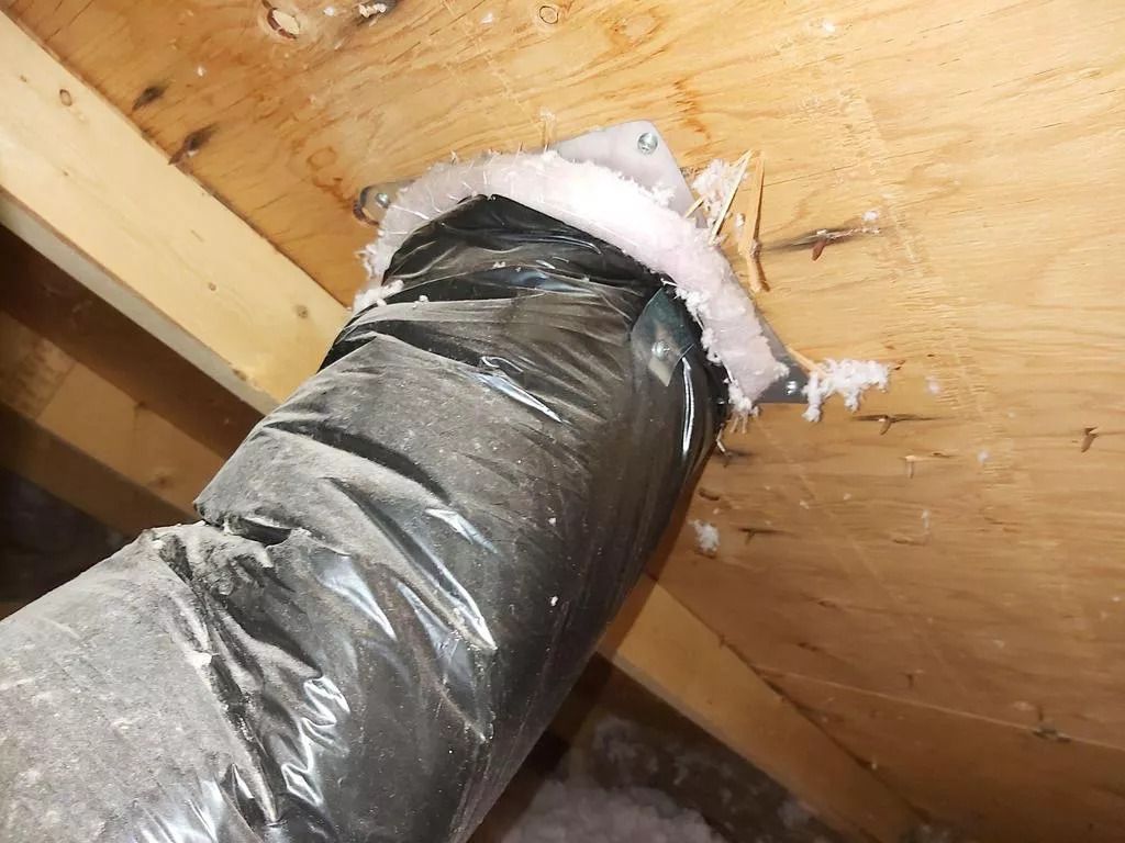 Insulated bathroom fan hose in an attic