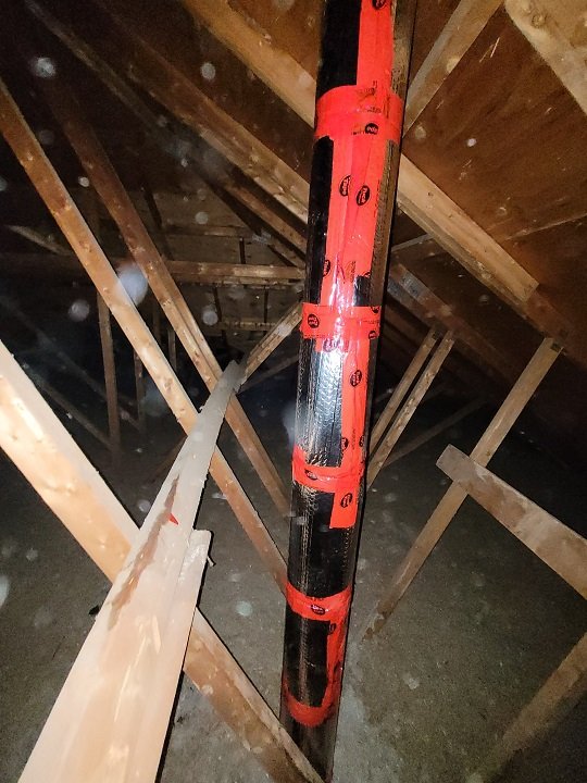 Insulated furnace exhaust pipe in an attic
