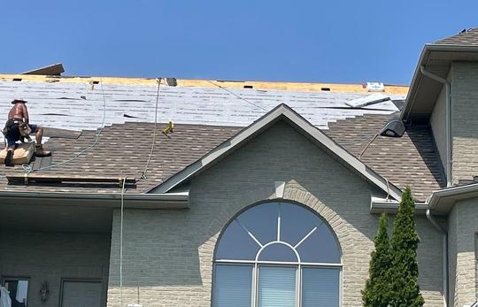 Roof underlayments and new shingles installed on a house